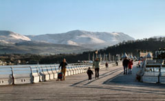 Visitors braving a fresh day on Garth Pier, Bangor, Gwynedd. 