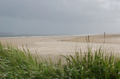 The beach and storm clouds at Burry Port Harbour