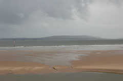 The beach and storm clouds at Burry Port Harbour