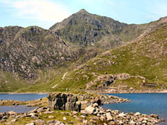 Yr Wydffa from Llyn Llydaw. Note the old Britannia copper crushing works and the Miners Track rising from Llyn Llydaw to Glaslyn. 